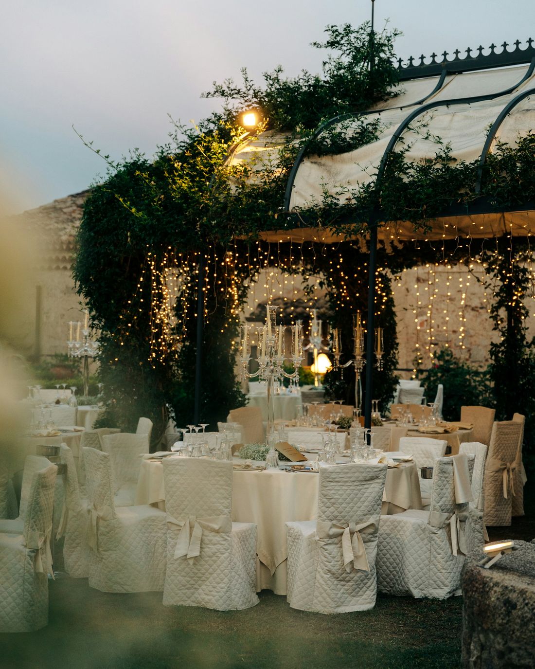 Reception tables under warm hanging lights