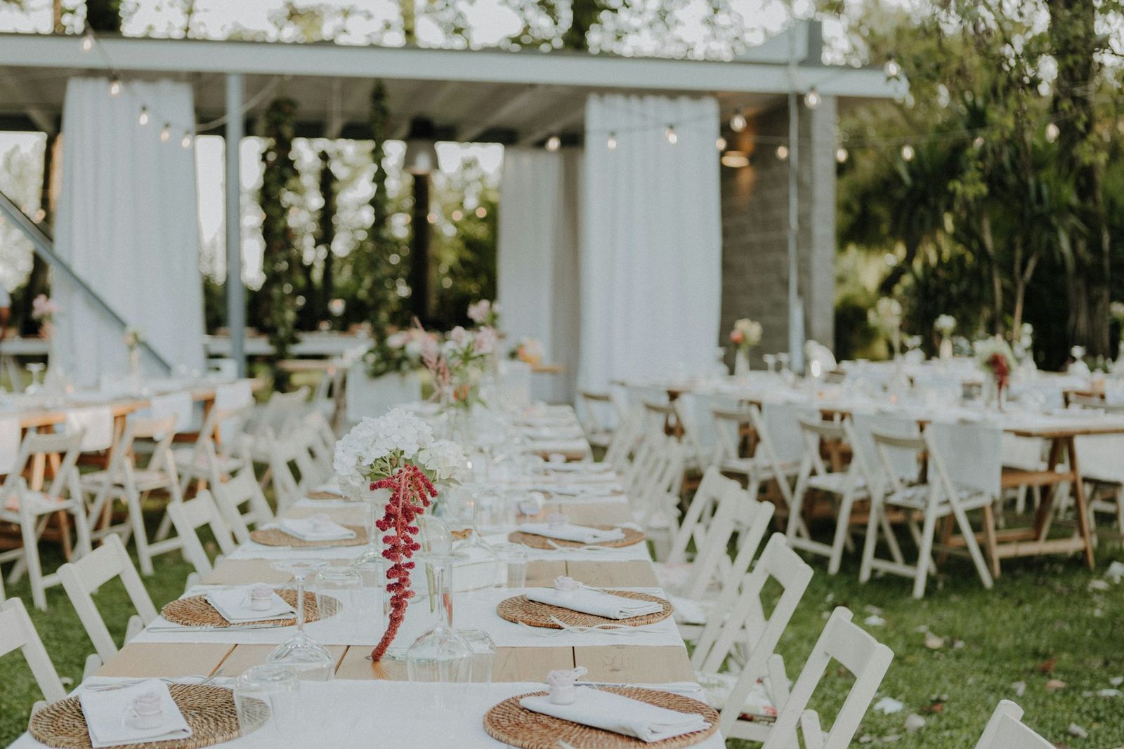 Reception tables set inside a white open pavilion
