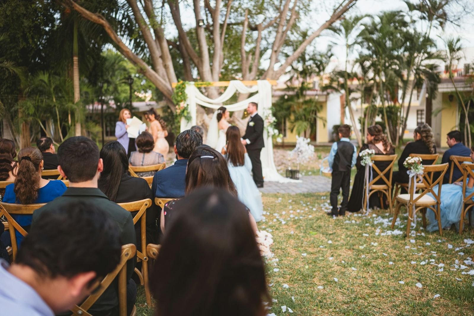 A couple exchanging vows in a garden ceremony